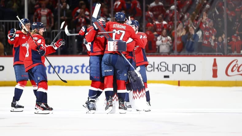 Mar 22, 2024; Washington, District of Columbia, USA; Washington Capitals players celebrate after defeating the Carolina Hurricanes during a shootout at Capital One Arena. Mandatory Credit: Amber Searls-USA TODAY Sports