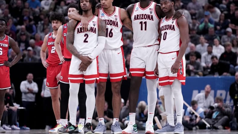 Mar 23, 2024; Salt Lake City, UT, USA; Arizona Wildcats guard Caleb Love (2), forward Keshad Johnson (16), center Oumar Ballo (11) and guard Jaden Bradley (0) watch a technical free throw during the second half in the second round of the 2024 NCAA Tournament against the Dayton Flyers at Vivint Smart Home Arena-Delta Center. Mandatory Credit: Gabriel Mayberry-USA TODAY Sports