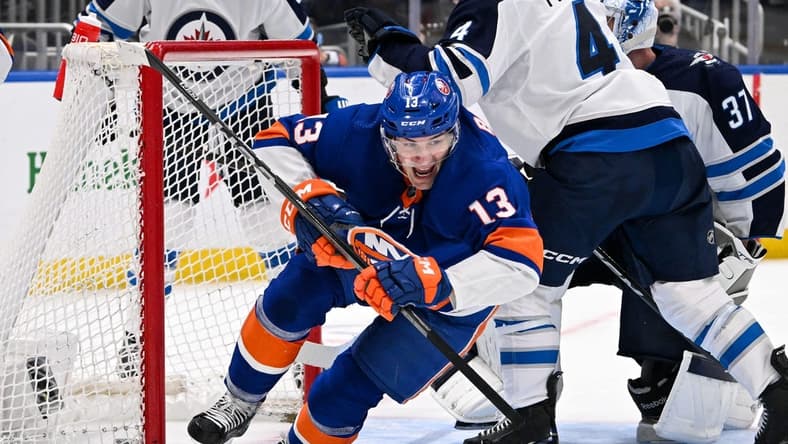 Mar 23, 2024; Elmont, New York, USA; New York Islanders center Mathew Barzal (13) celebrates his goal against the Winnipeg Jets during the second period at UBS Arena. Mandatory Credit: Dennis Schneidler-USA TODAY Sports
