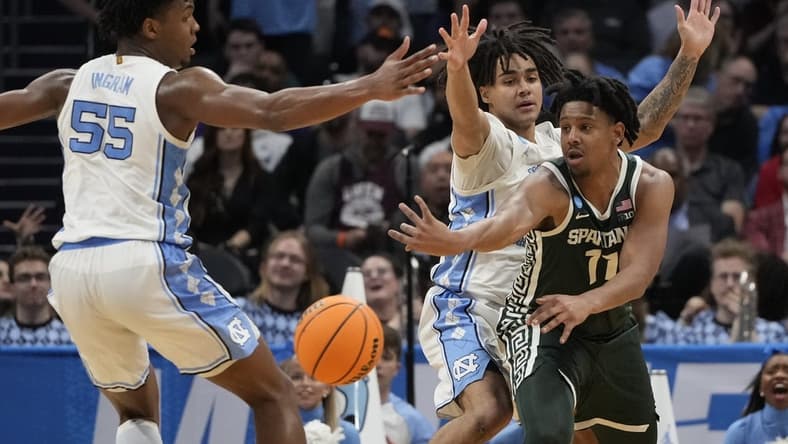 March 23, 2024, Charlotte, NC, USA; Michigan State Spartans guard A.J. Hoggard (11) passes away from North Carolina Tar Heels forward Harrison Ingram (55) and North Carolina Tar Heels guard Elliot Cadeau (2)  in the second round of the 2024 NCAA Tournament at the Spectrum Center. Mandatory Credit: Bob Donnan-USA TODAY Sports