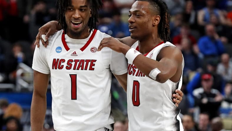 Mar 23, 2024; Pittsburgh, PA, USA; North Carolina State Wolfpack guard Jayden Taylor (1) celebrates with guard DJ Horne (0) after beating the Oakland Golden Grizzlies in the second round of the 2024 NCAA Tournament at PPG Paints Arena. Mandatory Credit: Charles LeClaire-USA TODAY Sports