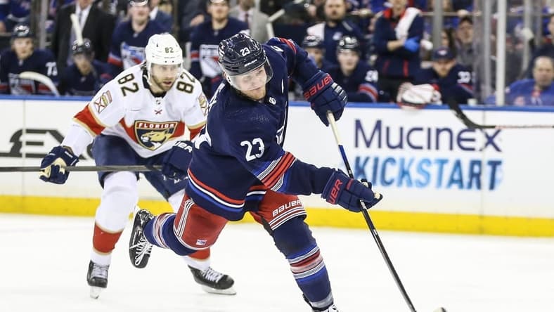 Mar 23, 2024; New York, New York, USA; New York Rangers defenseman Adam Fox (23) attempts a shot on goal in the second period against the Florida Panthers at Madison Square Garden. Mandatory Credit: Wendell Cruz-USA TODAY Sports