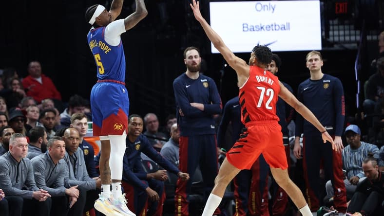 Mar 23, 2024; Portland, Oregon, USA;  Denver Nuggets guard Kentavious Caldwell-Pope (5) shoots the ball over Portland Trail Blazers guard Rayan Rupert (72) in the first quarter at Moda Center. Mandatory Credit: Jaime Valdez-USA TODAY Sports