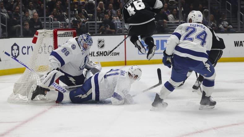 Mar 23, 2024; Los Angeles, California, USA; Los Angeles Kings center Blake Lizotte (46) leaps over Tampa Bay Lighting defensemen Erik Cernak (81) during the second period of an NHL hockey game at Crypto.com Arena. Mandatory Credit: Yannick Peterhans-USA TODAY Sports