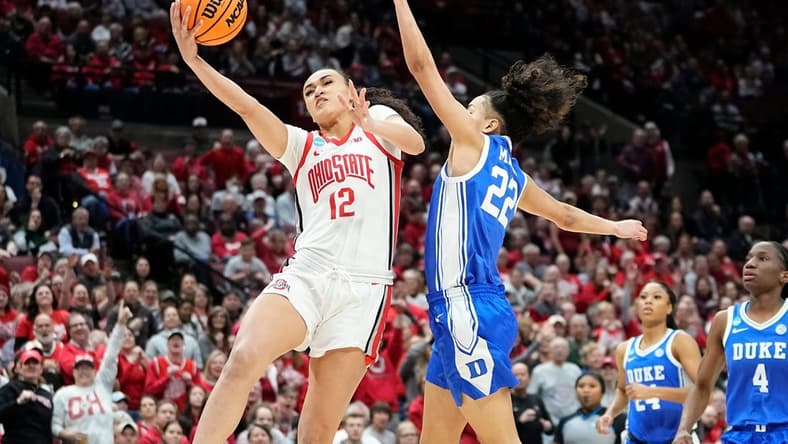 Ohio State guard Celeste Taylor (12) hits a layup around Duke guard Taina Mair (22) during the first half of their women's NCAA Tournament game at Value City Arena.