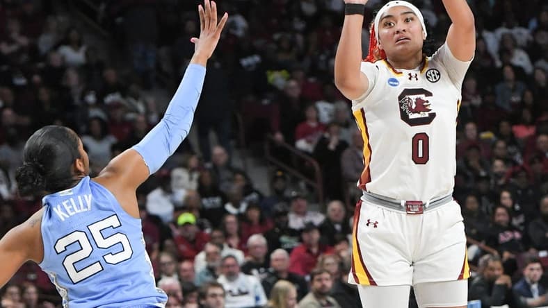 Mar 24, 2034; Columbia, So Carolina, USA;  South Carolina guard Te-Hina Paopao (0) makes a three-point shot near University of North Carolina guard Deja Kelly (25) during the second quarter of the second round NCAA Women's Basketball Tournament game at the Colonial Life Center.  Mandatory Credit: Ken Ruinard-USA TODAY Sports via Greenville News