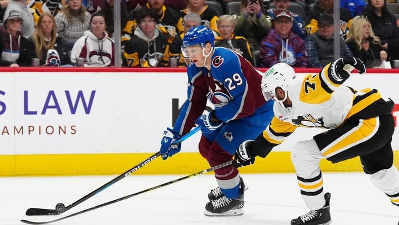 Mar 24, 2024; Denver, Colorado, USA; Pittsburgh Penguins defenseman Pierre-Olivier Joseph (73) defends on Colorado Avalanche center Nathan MacKinnon (29) in second period at Ball Arena. Mandatory Credit: Ron Chenoy-USA TODAY Sports