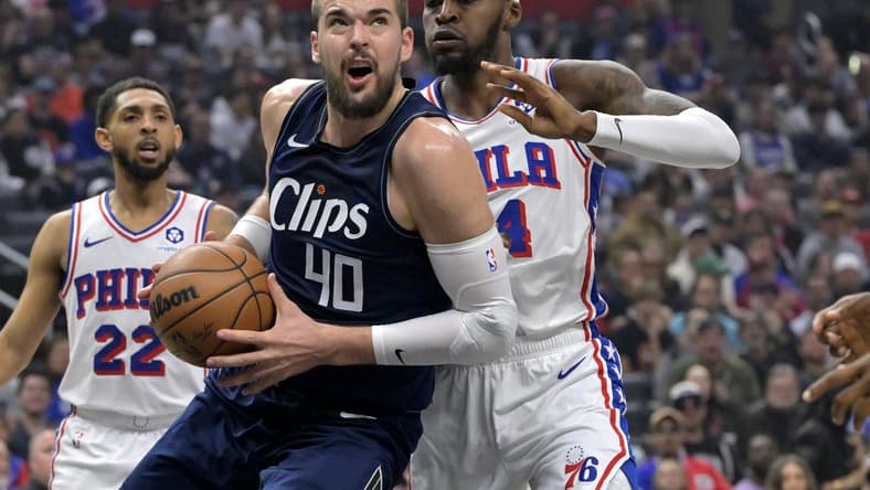Mar 24, 2024; Los Angeles, California, USA;  Los Angeles Clippers center Ivica Zubac (40) is defended by Philadelphia 76ers forward Paul Reed (44) as he drives to the basket in the first half at Crypto.com Arena. Mandatory Credit: Jayne Kamin-Oncea-USA TODAY Sports