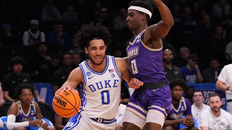 Mar 24, 2024; Brooklyn, NY, USA; Duke Blue Devils guard Jared McCain (0) dribbles the ball past James Madison Dukes guard Xavier Brown (0) in the second round of the 2024 NCAA Tournament at Barclays Center. Mandatory Credit: Robert Deutsch-USA TODAY Sports