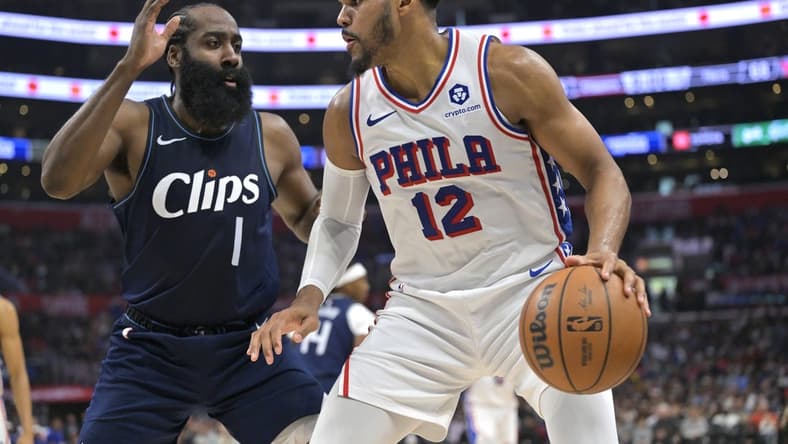 Mar 24, 2024; Los Angeles, California, USA;   Philadelphia 76ers forward Tobias Harris (12) is defended by Los Angeles Clippers guard James Harden (1) in the second half at Crypto.com Arena. Mandatory Credit: Jayne Kamin-Oncea-USA TODAY Sports