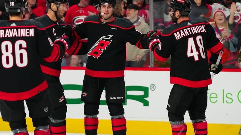 Mar 24, 2024; Raleigh, North Carolina, USA; Carolina Hurricanes defenseman Brady Skjei (76) celebrates his goal with left wing Jordan Martinook (48) and center Jordan Staal (11) against the Toronto Maple Leafs during the first period at PNC Arena. Mandatory Credit: James Guillory-USA TODAY Sports