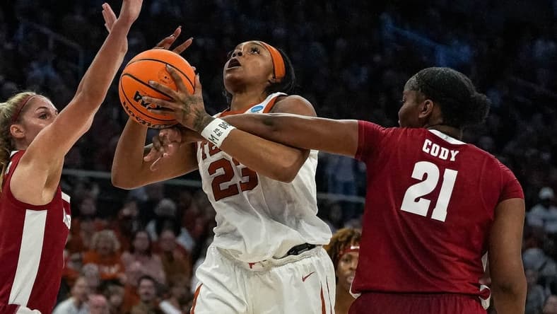 Texas forward Aaliyah Moore (23) is fouled by Alabama forward Essence Cody (21).