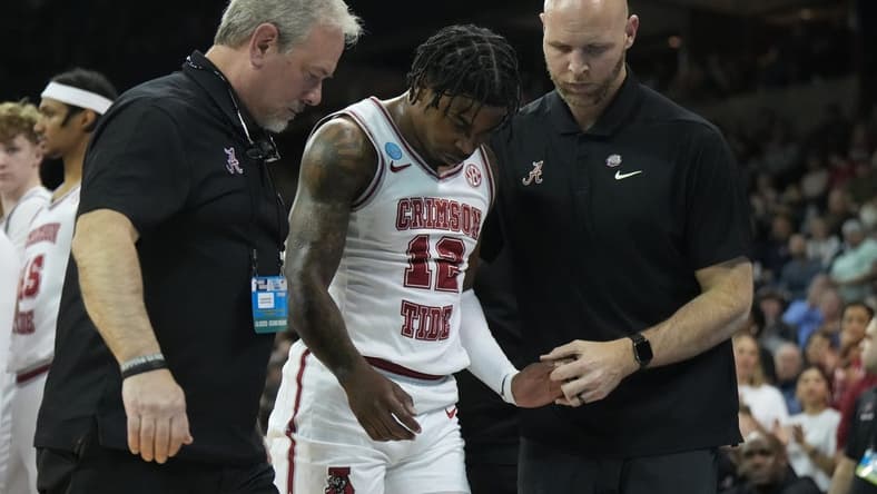 Mar 24, 2024; Spokane, WA, USA; Alabama Crimson Tide guard Latrell Wrightsell Jr. (12) is attended to by official in the first half against the Grand Canyon Antelopes at Spokane Veterans Memorial Arena. Mandatory Credit: Kirby Lee-USA TODAY Sports