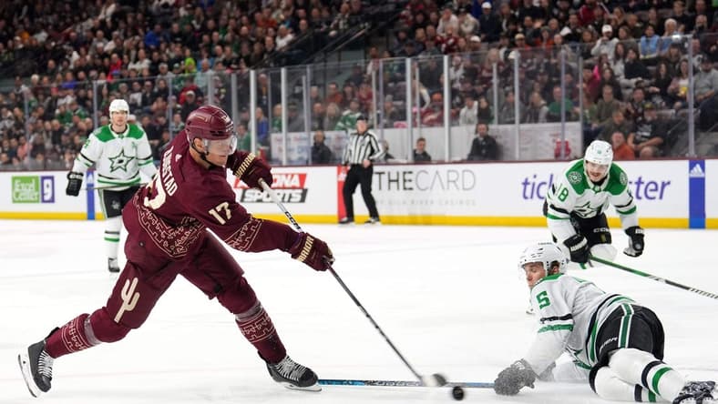 Mar 24, 2024; Tempe, Arizona, USA; Arizona Coyotes center Nick Bjugstad (17) shoots the puck by Dallas Stars defenseman Nils Lundkvist (5) during the second period at Mullett Arena. Mandatory Credit: Joe Camporeale-USA TODAY Sports