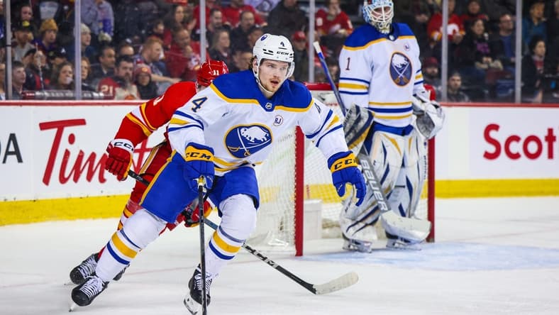 Mar 24, 2024; Calgary, Alberta, CAN; Buffalo Sabres defenseman Bowen Byram (4) controls the puck against the Calgary Flames during the second period at Scotiabank Saddledome. Mandatory Credit: Sergei Belski-USA TODAY Sports