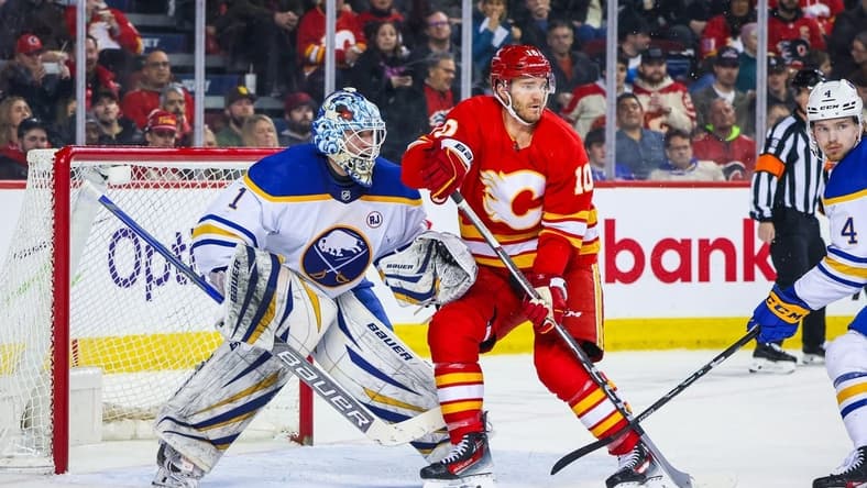 Mar 24, 2024; Calgary, Alberta, CAN; Calgary Flames center Jonathan Huberdeau (10) screens in front of Buffalo Sabres goaltender Ukko-Pekka Luukkonen (1) during the second period at Scotiabank Saddledome. Mandatory Credit: Sergei Belski-USA TODAY Sports