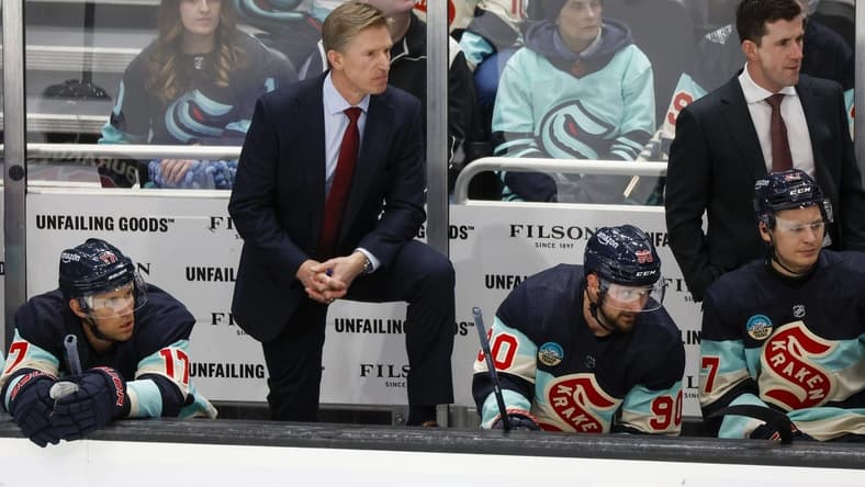 Mar 24, 2024; Seattle, Washington, USA; Seattle Kraken head coach Dave Hakstol, back left, stands behind the bench as center Jaden Schwartz (17) and left wing Tomas Tatar (90) watch the final seconds of the third period against the Montreal Canadiens at Climate Pledge Arena. Mandatory Credit: Joe Nicholson-USA TODAY Sports