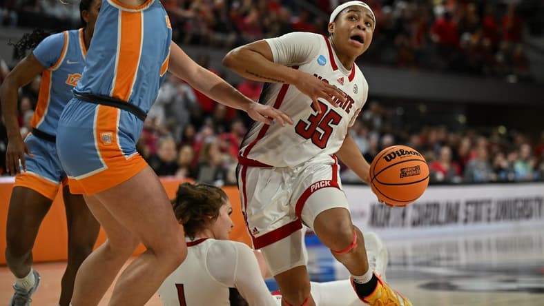 Mar 25, 2024; Raleigh, North Carolina, USA; NC State Wolfpack guard Zoe Brooks (35) drives past Tennessee Lady Vols guard Sara Puckett (1) in the second round of the 2024 NCAA Women's Tournament at James T. Valvano Arena at William Neal Reynolds. Mandatory Credit: William Howard-USA TODAY Sports