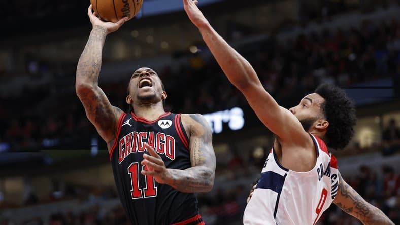 Mar 25, 2024; Chicago, Illinois, USA; Chicago Bulls forward DeMar DeRozan (11) goes to the basket against Washington Wizards forward Justin Champagnie (99) during the first half at United Center. Mandatory Credit: Kamil Krzaczynski-USA TODAY Sports