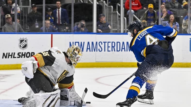 Mar 25, 2024; St. Louis, Missouri, USA;  Vegas Golden Knights goaltender Logan Thompson (36) defends the net against St. Louis Blues defenseman Nick Leddy (4) during the second period at Enterprise Center. Mandatory Credit: Jeff Curry-USA TODAY Sports