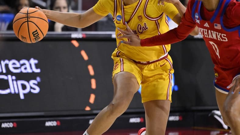 Mar 25, 2024; Los Angeles, CA, USA; USC Trojans guard JuJu Watkins (12) drives to the basket as Kansas Jayhawks guard Wyvette Mayberry (0) defends during an NCAA Women’s Tournament 2nd round game at Galen Center. Mandatory Credit: Robert Hanashiro-USA TODAY Sports