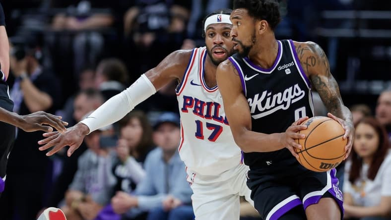 Mar 25, 2024; Sacramento, California, USA; Sacramento Kings guard Malik Monk (0) controls the ball against Philadelphia 76ers guard Buddy Hield (17) during the second quarter at Golden 1 Center. Mandatory Credit: Sergio Estrada-USA TODAY Sports