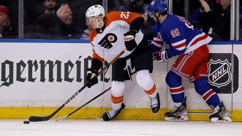 Mar 26, 2024; New York, New York, USA; Philadelphia Flyers defenseman Ronnie Attard (23) looks to pass the puck against New York Rangers center Jack Roslovic (96) during the first period at Madison Square Garden. Mandatory Credit: Brad Penner-USA TODAY Sports