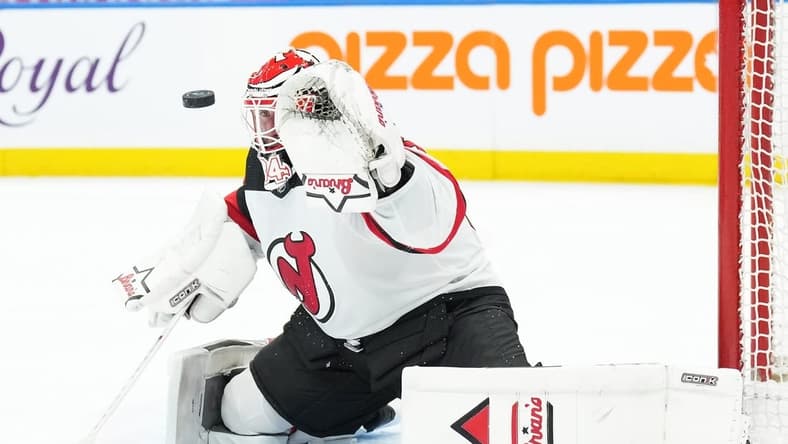 Mar 26, 2024; Toronto, Ontario, CAN; New Jersey Devils goaltender Jake Allen (34) attempts to stop the puck against the Toronto Maple Leafs during the first period at Scotiabank Arena. Mandatory Credit: Nick Turchiaro-USA TODAY Sports