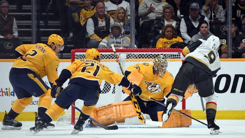 Mar 26, 2024; Nashville, Tennessee, USA; Nashville Predators goaltender Juuse Saros (74) makes a save on a shot by Vegas Golden Knights center Jack Eichel (9) during the first period at Bridgestone Arena. Mandatory Credit: Christopher Hanewinckel-USA TODAY Sports