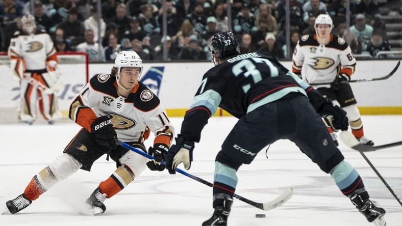 Mar 26, 2024; Seattle, Washington, USA; Anaheim Ducks forward Trevor Zegras (11) skates against Seattle Kraken forward Yanni Gourde (37) during the first period at Climate Pledge Arena. Mandatory Credit: Stephen Brashear-USA TODAY Sports