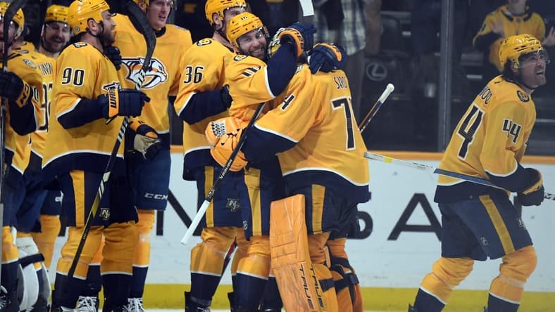 Mar 26, 2024; Nashville, Tennessee, USA; Nashville Predators left wing Jason Zucker (16) celebrates with goaltender Juuse Saros (74) after an overtime win against the Vegas Golden Knights at Bridgestone Arena. Mandatory Credit: Christopher Hanewinckel-USA TODAY Sports