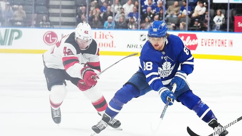 Mar 26, 2024; Toronto, Ontario, CAN; Toronto Maple Leafs right wing William Nylander (88) battles for the puck with New Jersey Devils defenseman Brendan Smith (2) during the third period at Scotiabank Arena. Mandatory Credit: Nick Turchiaro-USA TODAY Sports