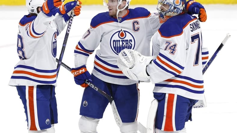 Mar 26, 2024; Winnipeg, Manitoba, CAN; Edmonton Oilers right wing Connor Brown (28), Edmonton Oilers center Connor McDavid (97) and Edmonton Oilers goaltender Stuart Skinner (74) celebrate their overtime victory against the Winnipeg Jets at Canada Life Centre. Mandatory Credit: James Carey Lauder-USA TODAY Sports