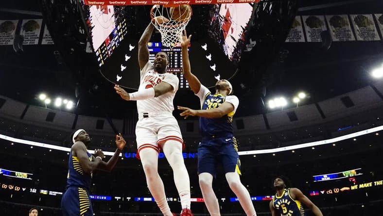 Mar 27, 2024; Chicago, Illinois, USA; Chicago Bulls center Andre Drummond (3) dunks on Indiana Pacers center Myles Turner (33) during the first quarter at United Center. Mandatory Credit: David Banks-USA TODAY Sports