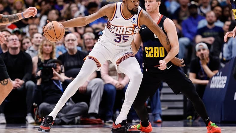 Mar 27, 2024; Denver, Colorado, USA; Phoenix Suns forward Kevin Durant (35) controls the ball as Denver Nuggets guard Collin Gillespie (21) guards in the second quarter at Ball Arena. Mandatory Credit: Isaiah J. Downing-USA TODAY Sports