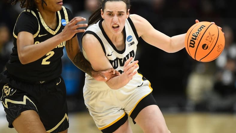 Iowa's Caitlin Clark (22) tries to get to the basket while guarded by Colorado's Tameiya Sadler (2) during the Sweet 16 of the NCAA college basketball tournament at Climate Pledge Arena in Seattle, WA on Friday, March 24, 2023.