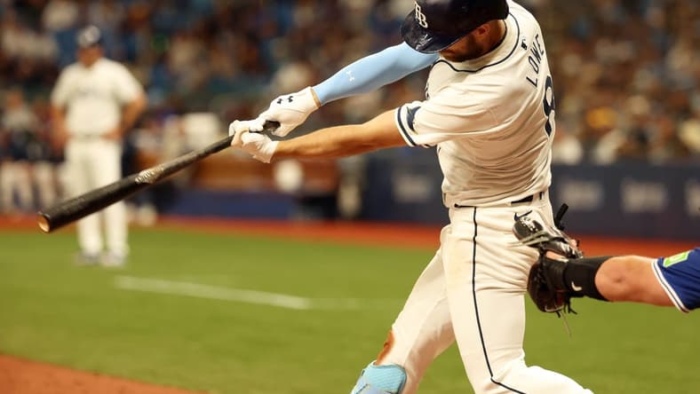Mar 28, 2024; St. Petersburg, Florida, USA; Tampa Bay Rays first baseman Yandy Diaz (2) singles during the eighth inning against the Toronto Blue Jays at Tropicana Field. Mandatory Credit: Kim Klement Neitzel-USA TODAY Sports