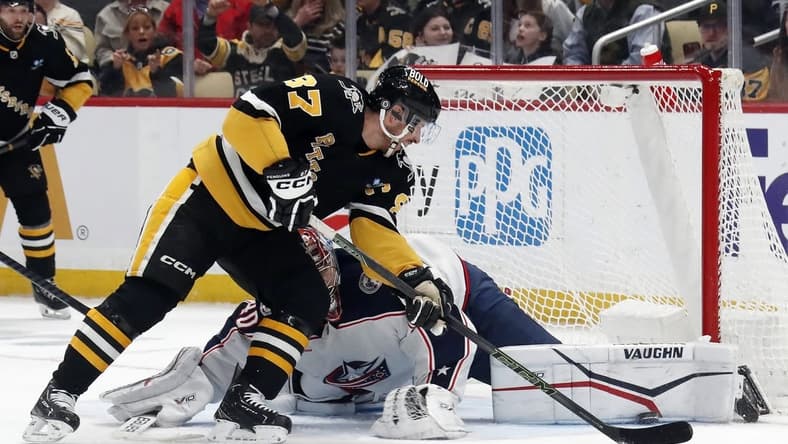 Mar 28, 2024; Pittsburgh, Pennsylvania, USA; Columbus Blue Jackets goaltender Daniil Tarasov (40) makes a pad save against Pittsburgh Penguins center Sidney Crosby (87) during the first period at PPG Paints Arena. Mandatory Credit: Charles LeClaire-USA TODAY Sports