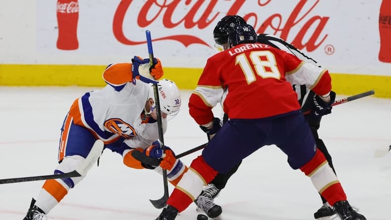 Mar 28, 2024; Sunrise, Florida, USA; New York Islanders center Kyle MacLean (32) and Florida Panthers center Steven Lorentz (18) face-off during the first period at Amerant Bank Arena. Mandatory Credit: Sam Navarro-USA TODAY Sports
