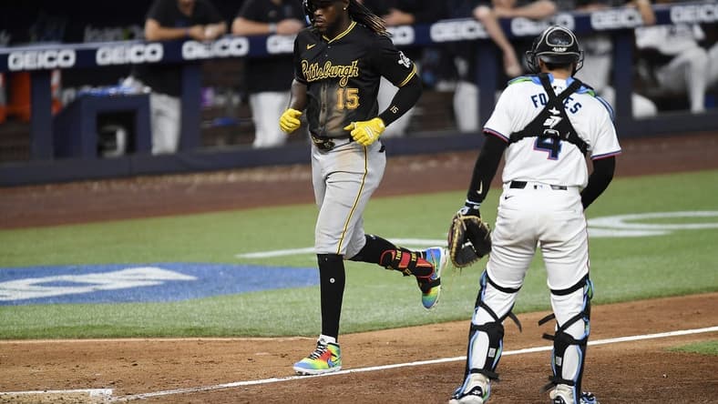 Mar 28, 2024; Miami, Florida, USA; Pittsburgh Pirates shortstop Oneil Cruz (15) trots to home plate in front of Miami Marlins catcher Nick Fortes (4) during the eighth inning, at loanDepot Park. Mandatory Credit: Michael Laughlin-USA TODAY Sports