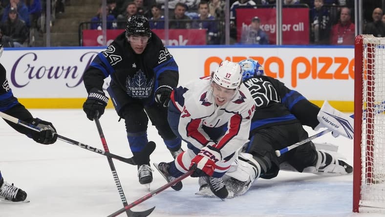 Mar 28, 2024; Toronto, Ontario, CAN; Toronto Maple Leafs forward Connor Dewar (24) knocks Washington Capitals forward Dylan Strome (17) off of the puck as he breaks in on Toronto Maple Leafs goaltender Joseph Woll (60) during the second period at Scotiabank Arena. Mandatory Credit: John E. Sokolowski-USA TODAY Sports