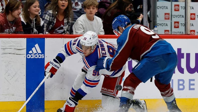 Mar 28, 2024; Denver, Colorado, USA; New York Rangers center Alex Wennberg (91) and Colorado Avalanche left wing Zach Parise (9) battle for the puck in the first period at Ball Arena. Mandatory Credit: Isaiah J. Downing-USA TODAY Sports