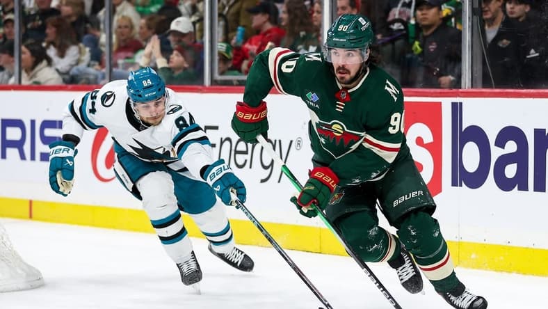 Mar 28, 2024; Saint Paul, Minnesota, USA; Minnesota Wild center Marcus Johansson (90) skates with the puck as San Jose Sharks defenseman Jan Rutta (84) defends during the second period at Xcel Energy Center. Mandatory Credit: Matt Krohn-USA TODAY Sports