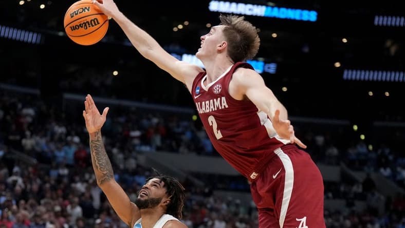 Mar 28, 2024; Los Angeles, CA, USA; Alabama Crimson Tide forward Grant Nelson (2) blocks North Carolina Tar Heels guard RJ Davis (4) in the second half in the semifinals of the West Regional of the 2024 NCAA Tournament at Crypto.com Arena. Mandatory Credit: Kirby Lee-USA TODAY Sports