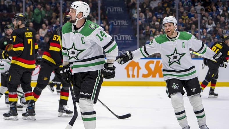 Mar 28, 2024; Vancouver, British Columbia, CAN; Dallas Stars forward Joe Pavelski (16) watches as forward Jamie Benn (14) celebrates his goal against the Vancouver Canucks in the third period at Rogers Arena. Dallas won 3 - 1. Mandatory Credit: Bob Frid-USA TODAY Sports