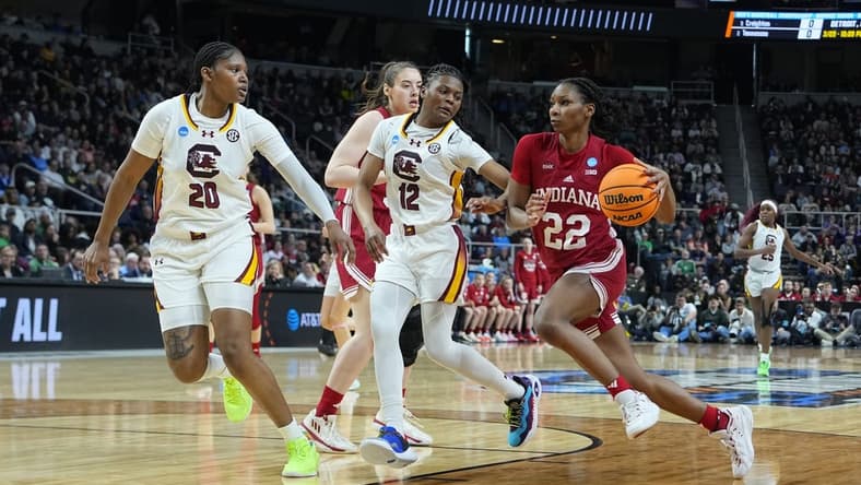 Mar 29, 2024; Albany, NY, USA; Indiana Hoosiers guard Chloe Moore-McNeil (22) drives the ball against South Carolina Gamecocks guard MiLaysia Fulwiley (12) and forward Sania Feagin (20) during the first half in the semifinals of the Albany Regional of the 2024 NCAA Tournament at the MVP Arena at MVP Arena. Mandatory Credit: Gregory Fisher-USA TODAY Sports