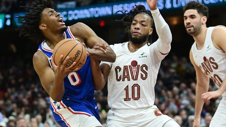Mar 29, 2024; Cleveland, Ohio, USA; Philadelphia 76ers guard Tyrese Maxey (0) drives to the basket against Cleveland Cavaliers guard Darius Garland (10) during the first half at Rocket Mortgage FieldHouse. Mandatory Credit: Ken Blaze-USA TODAY Sports