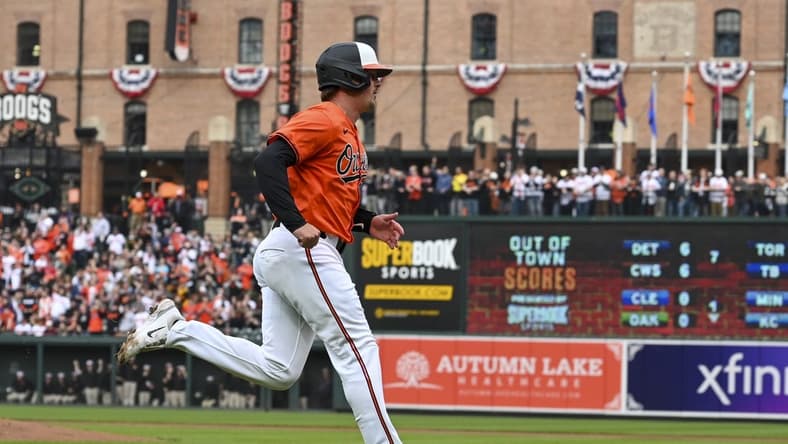 Mar 30, 2024; Baltimore, Maryland, USA; Baltimore Orioles catcher Adley Rutschman (35) scores on first baseman Ryan Mountcastle (not pictured) first inning double against the Los Angeles Angels at Oriole Park at Camden Yards. Mandatory Credit: Tommy Gilligan-USA TODAY Sports