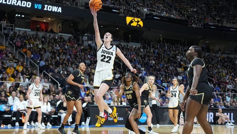 Mar 30, 2024; Albany, NY, USA; Iowa Hawkeyes guard Caitlin Clark (22) shoots the ball past Colorado Buffaloes guard Jaylyn Sherrod (0) during the second half in the semifinals of the Albany Regional of the 2024 NCAA Tournament at MVP Arena. Mandatory Credit: Gregory Fisher-USA TODAY Sports