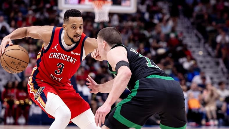 Mar 30, 2024; New Orleans, Louisiana, USA; New Orleans Pelicans guard CJ McCollum (3) dribbles against Boston Celtics guard Payton Pritchard (11) during the second half at Smoothie King Center. Mandatory Credit: Stephen Lew-USA TODAY Sports